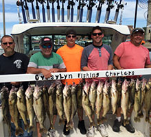 five guys holding a board of fish