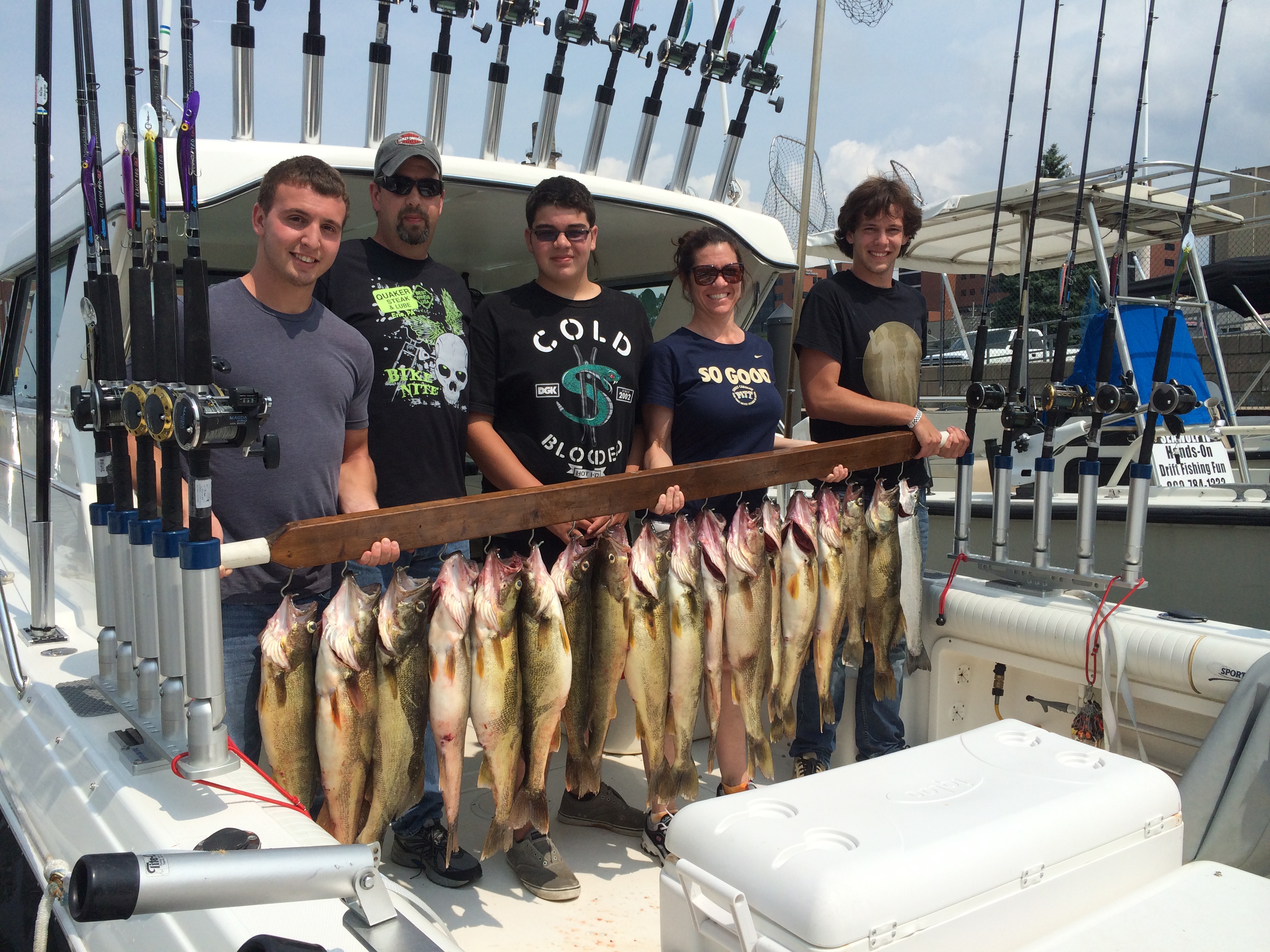 Smiling family holding fish