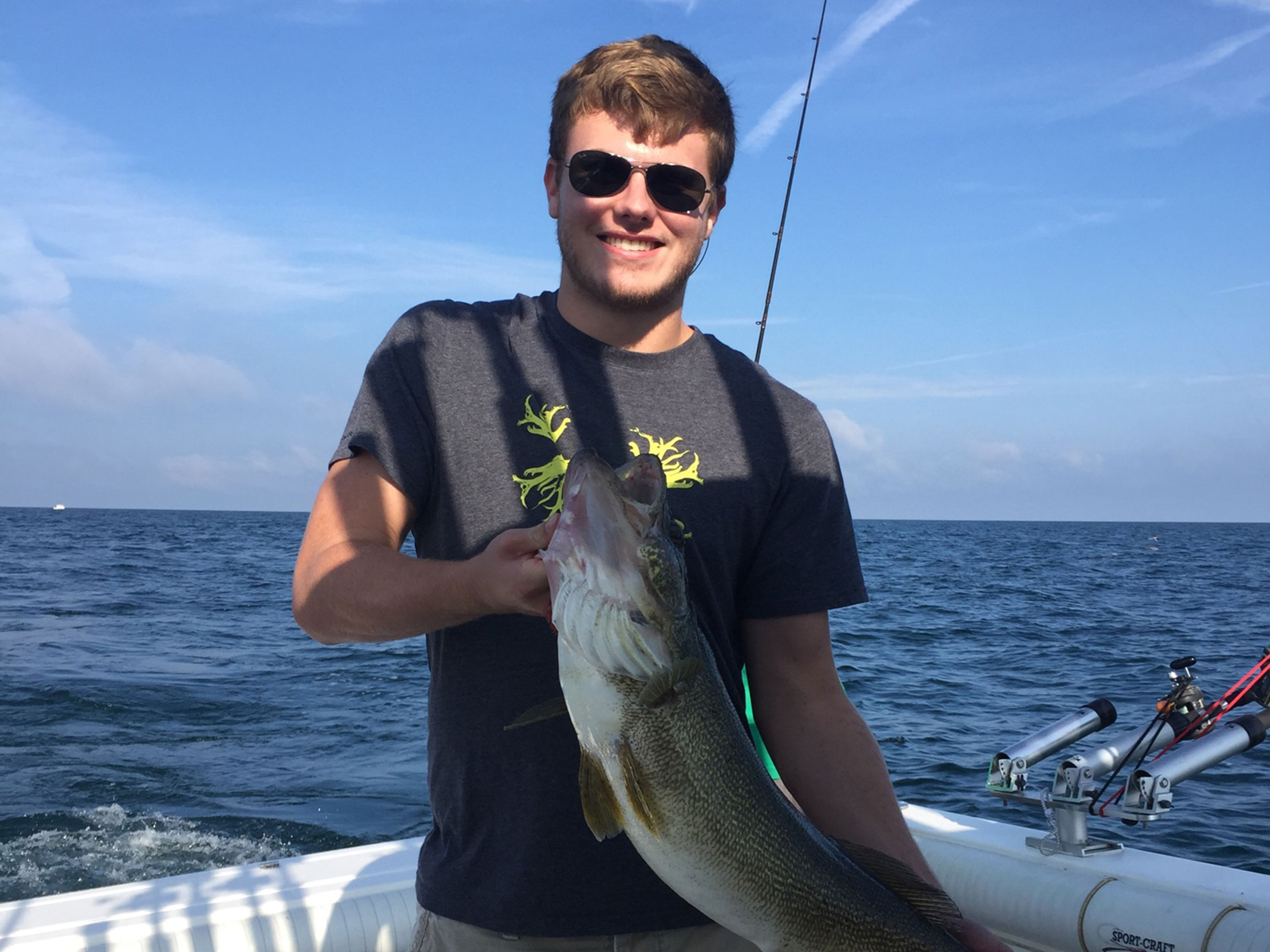 Smiling boy holding fish