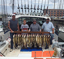 fishing crew with a board of fish