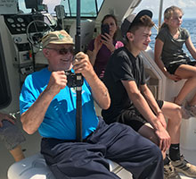 Captain Joe's dad winds in a big fish