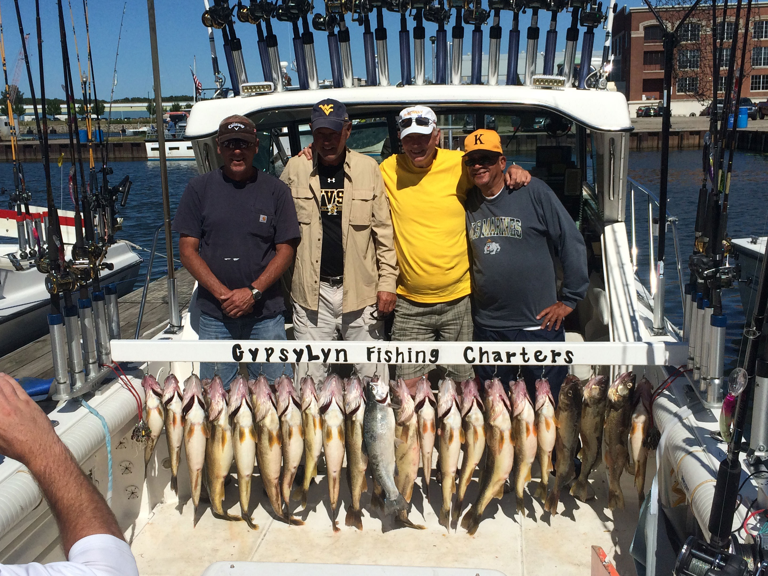 Smiling men holding fish