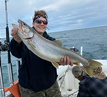 woman holding a big lake trout