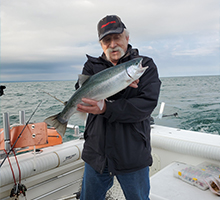 older gentleman with a steelhead