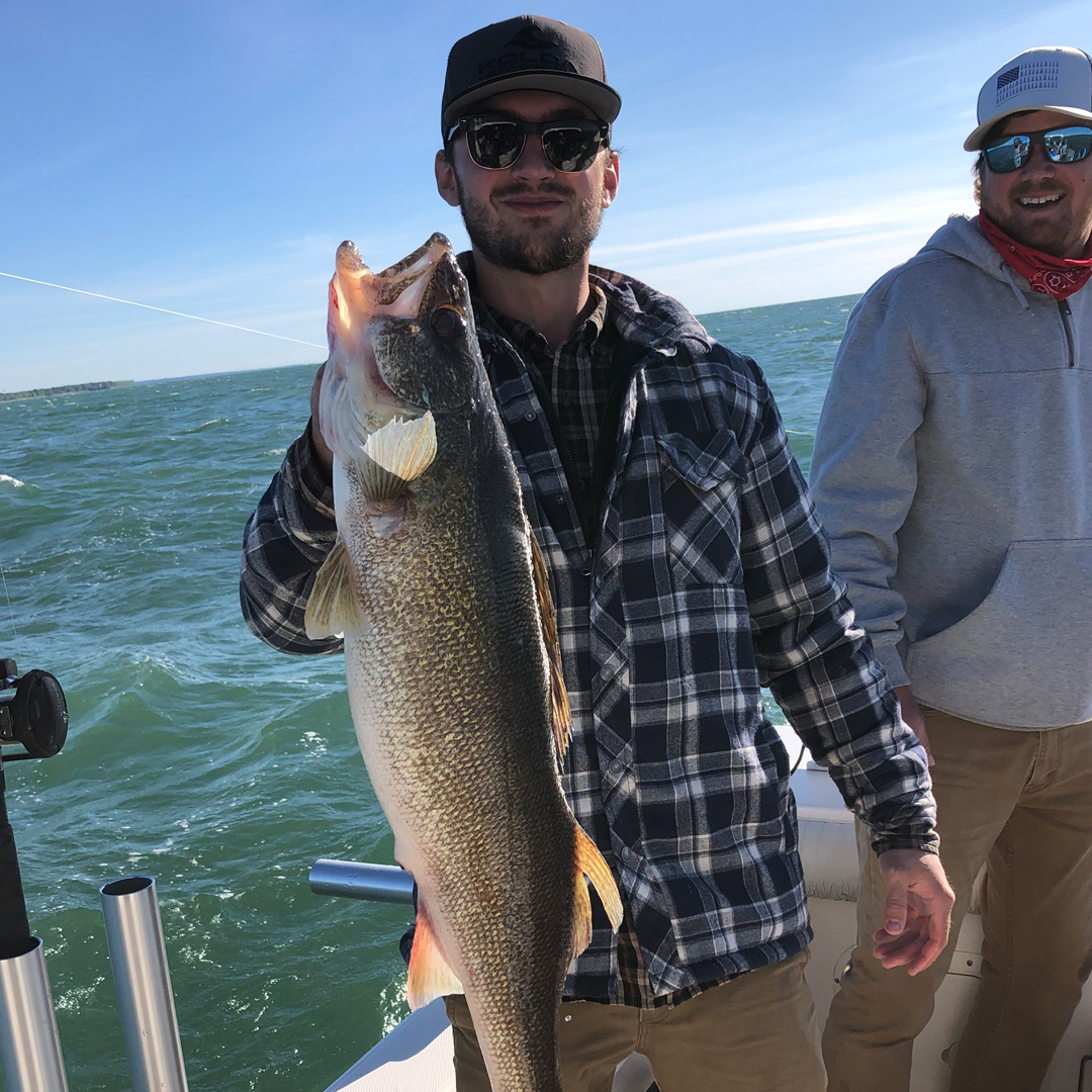 woman holding a big lake trout