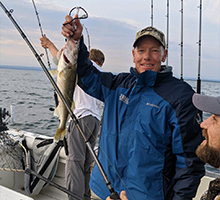 man holding a fish up high