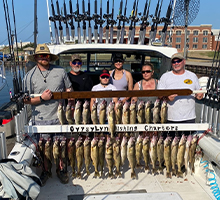 family and friends with two boards of fish