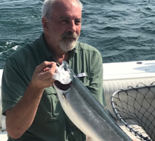 older gentleman holding a steelhead