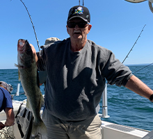 older gentleman grabbing a walleye