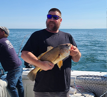 boy holding a big sheephead fish