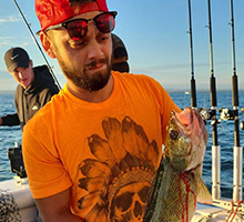 man holding a bloody walleye