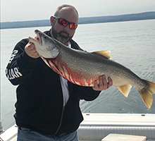 man holding a big lake trout