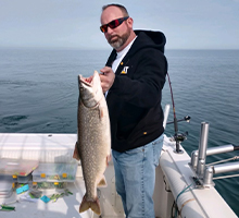 man holding a big lake trout